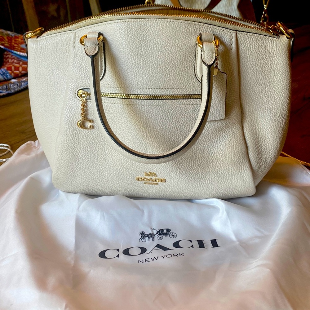 Coach cream colored purse. Excellent condition. Comes w/storage bag.